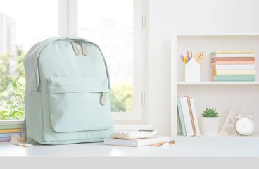Study desk with notebooks and backpack on home window view background © didecs