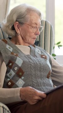 Newspaper, reading and glasses with old woman on sofa for obituary check, headlines and relax. Retirement, press release notice and article publication with senior person and tabloid in home