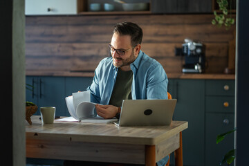 Man studying documents while working from home