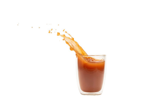 A dynamic splash of creamy brown liquid jumping out of clear glass