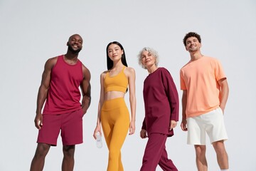 Fototapeta premium Diverse multigenerational group in coordinated activewear for wellness wallpaper background and lifestyle fitness marketing design