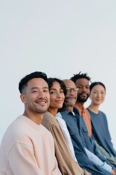 Vertical closeup portrait of a diverse group lined up and smiling for inclusive team profile background and banner design for corporate and community use