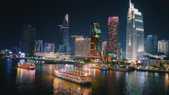 Aerial View of Dinner Cruise Boat Navigating Saigon River at Night in Ho Chi Minh City
bright boat searchlights, colorful reflections across the water, the lit-up cable-stayed bridge, glowing downtown