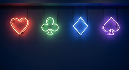 Fototapeta premium Neon playing card suit icons hanging on a dark wall with copy space