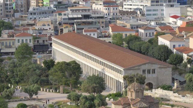 Expansive view panning across the Stoa of Attalos and the surrounding ancient Agora in the historic city of Athens.