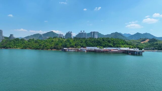January 14, 2023, Taiping Lake, China � Scenic 4K aerial of a wide lake and natural shoreline framed by distant hills and soft clouds.