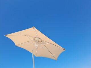 beach umbrella on blue sky © Евгения Смульская