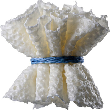 White Indonesian traditional cracker kerupuk tied with blue string on white