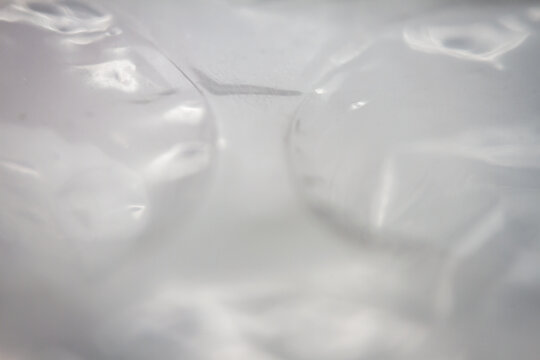 Extreme macro of plastic bubble wrap texture. Selective soft focus, shallow depth of field. Abstract dreamy background
