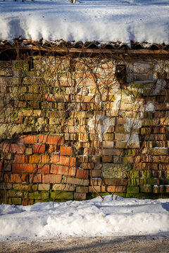 Old abandoned brick wall in winter. Architectural detail.