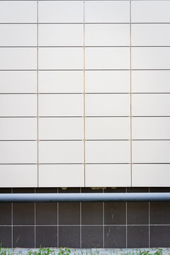 Modern white panel tile wall texture background. Architectural detail.