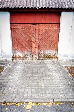 Old wooden gate in white brick wall. Architecture detail background