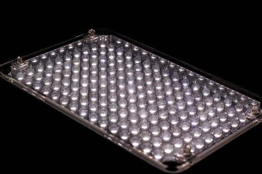 A rectangular LED light panel illuminated with rows of bright white diodes against a dark background.