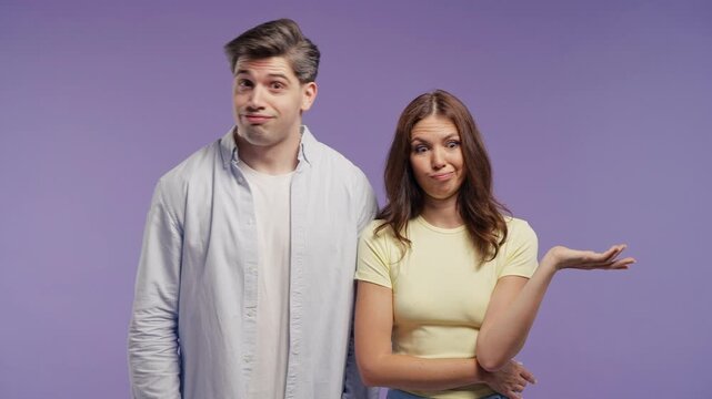 Young couple exchanging disapproving glances before rolling their eyes in disbelief. Judgment, skepticism, passive aggression, annoyance, criticism, gossip and negative reaction to someone's behavior.