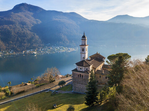 Aerial image of the parish church SS. Fedele e Simone istands on the high hill of Vico Morcote. Morcote at the Lake Lugano was once credited as one of the most beautiful Swiss villages.