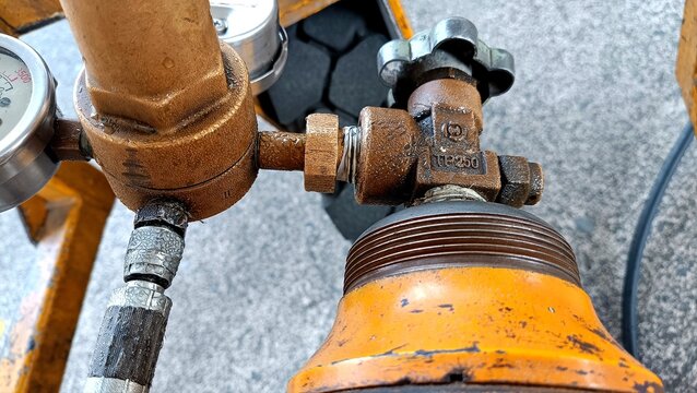 Aircraft tire nitrogen servicing equipment featuring high-pressure nitrogen cylinders and precision pressure regulator mounted on a ground support cart during aviation maintenance