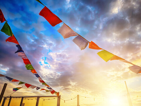 Colorful prayer flags against dramatic sunset sky in The Hague, Netherlands