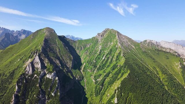 Aerial footage of the Belianske Tatry in Slovakia, featuring the mountain peaks Zdiarska Vidla and Havran. The view captures the dramatic ridgelines, rocky slopes and green alpine landscape