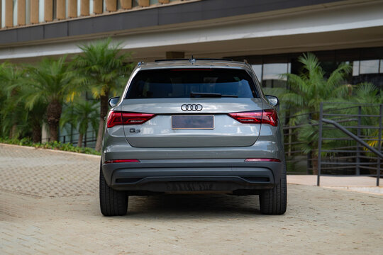 Grey Audi Q3 centered rear view outdoors, Compact luxury SUV on paved driveway