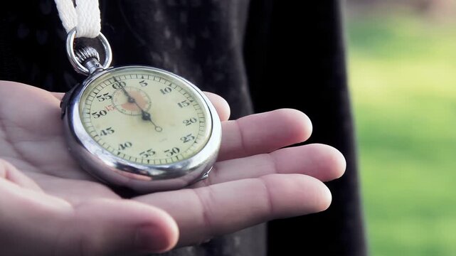 Vintage Stopwatch Hanging Around Neck Being Checked by Hand - 4K