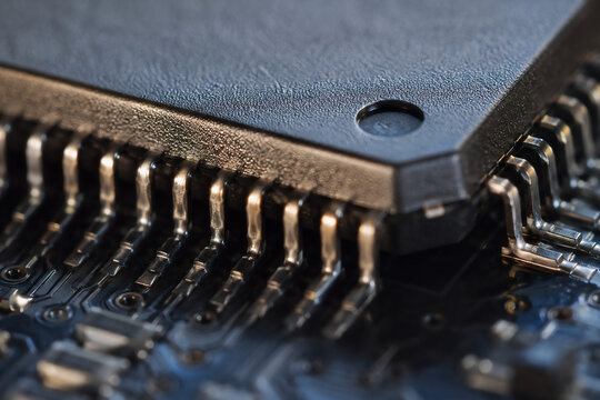 Extreme macro of a microprocessor surface showing pins and textures, editorial style