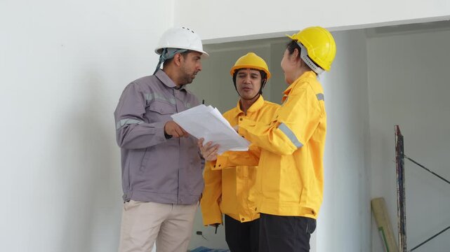 Construction inspectors and engineer discussing project details at an unfinished building site, teamwork, communication, safety compliance, site supervision, safety, construction project management.