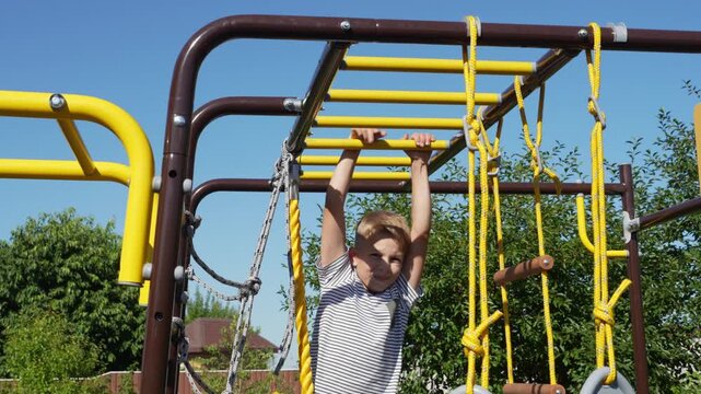 A boy playing on a children outdoor playground