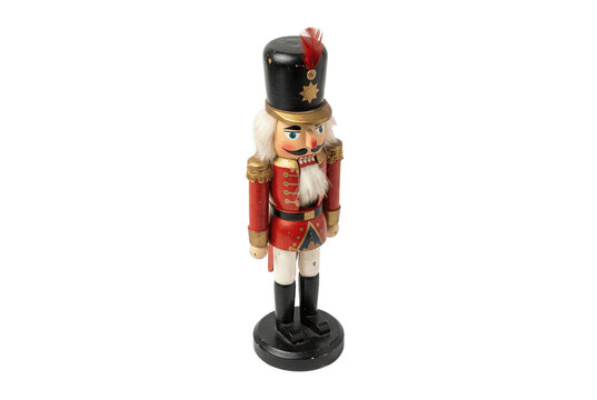 Classic wooden nutcracker soldier toy on black background.