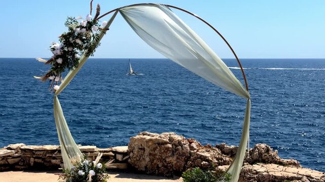 sailing boat passing through a wedding arc decoration on the ocean with perfect landscape and ambient sound