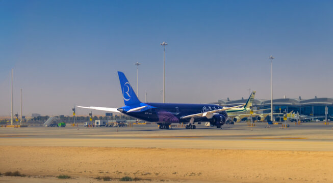 RIYADH, SAUDI ARABIA - JUNE 13, 2023: A daytime view of Riyadh Air airplane with its purple livery parked at King Khalid International Airport tarmac alongside other Saudi airlines