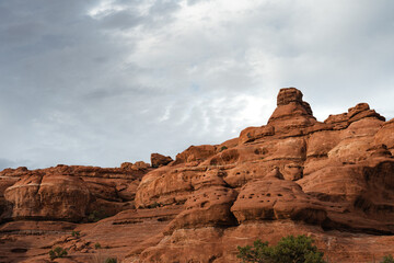 Clouds drift behind desert rock formations in Canyonlands National Park, in Utah © LB Photo Co