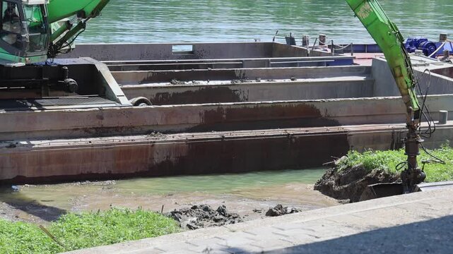 Long Crane Excavator With Rotary Clamshell Grab Bucket at River Barge Coast Cleaning Work