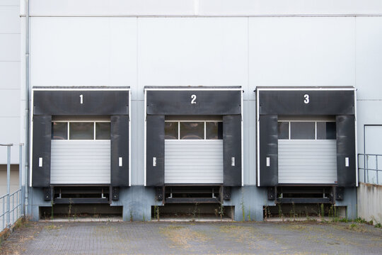 Modern logistics warehouse area with loading docks for truck, freight forwarding company, logistic industry in Germany, transportation and delivery