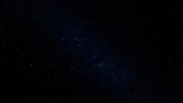 Dark night sky filled with numerous white and faint blue stars gently twinkling and slowly drifting across the frame. Abstract backdrop shaped by twinkling, nighttime and astronomy.