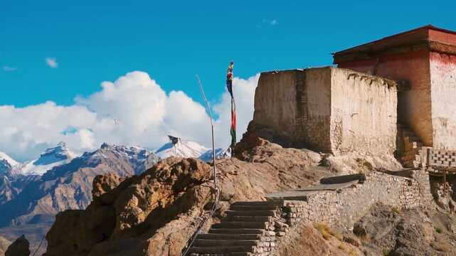 Historical Dhankar Fort against snow capped Himalaya mountains in Spiti Valley, Himachal Pradesh, India. Old ruined architecture of Dhankar monastery. Travel and holidays concept. ancient Buddhist mon