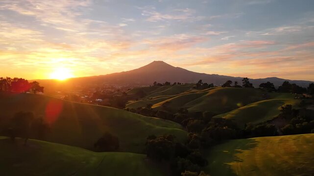 Aerial view of golden sunset light sweeping over the green slopes of Dougherty Hills with Mount Diablo standing tall in San Ramon California