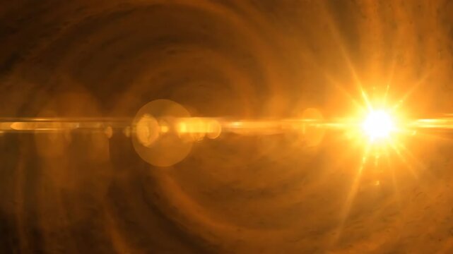 Cinematic slow pan across deep amber background featuring large intense lens flares with golden afterglow effects and light persistence trails