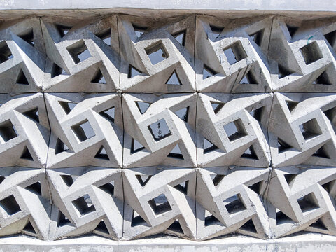 Decorative concrete screen block wall architectural detail with geometric lattice pattern in daylight