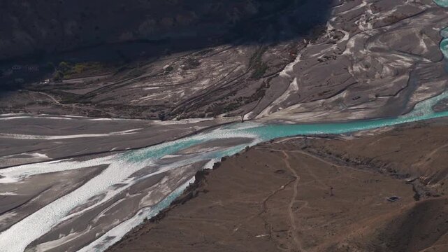 Confluence of the River Pin and River Spiti as seen from the top of the Dhankar Monastery in Spiti Valley, Himachal Pradesh, India. River flowing through a mountain valley. Dramatic nature background.