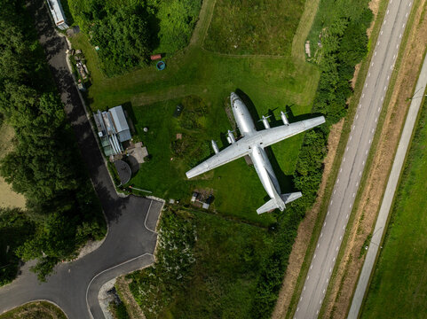 Valkse, Estonia - July 14 2026: Aerial drone view of a preserved Antonov An-12 military transport aircraft. Top-down perspective highlights the iconic four-engine turboprop airplane.