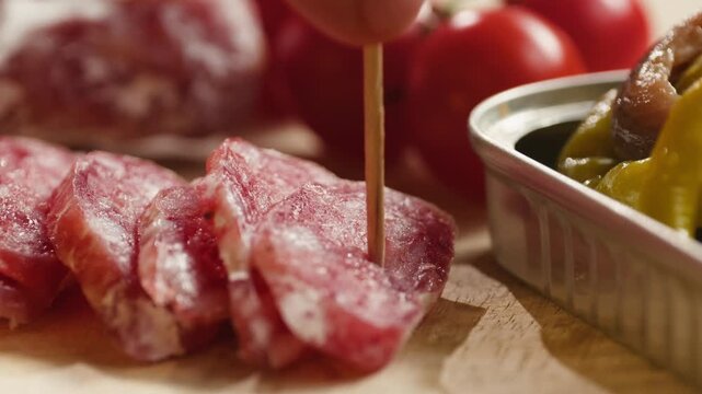 Mix of spanish pork sausages, Cutting board of appetizing catalonian snack - fuet, jamon, chorizo, olives, supermarket tapas food in spain, traditional cuisine. 
