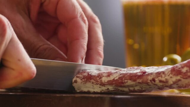 Mix of spanish pork sausages, Cutting board of appetizing catalonian snack - fuet, jamon, chorizo, olives, supermarket tapas food in spain, traditional cuisine. 