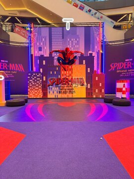 Spider-Man promotional display with cityscape backdrop in mall