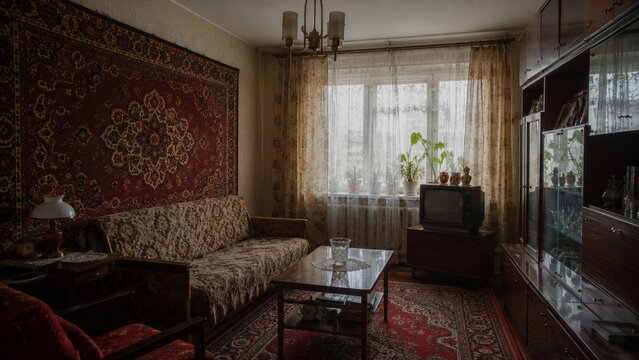 Cozy vintage Soviet living room with patterned carpet, classic furniture and television, showcasing nostalgic Eastern European home interior and retro lifestyle.