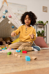 Joyful moments of a young boy exploring creativity at home © LIGHTFIELD STUDIOS