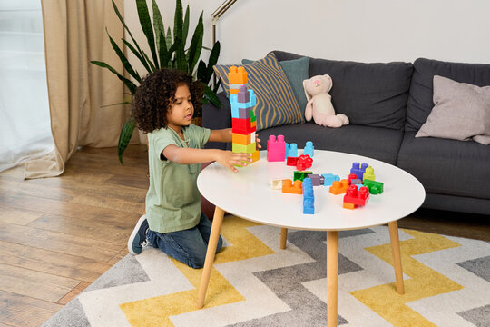 Happy african american boy engaged in imaginative play at home