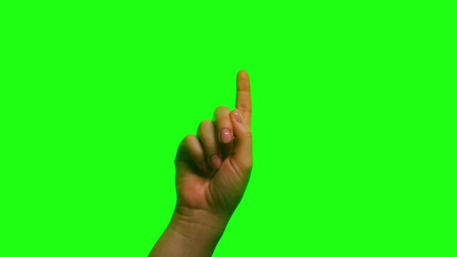 Close-up of a human hand tapping an invisible touchscreen with the index finger on a green screen background. Touch gesture for user interface, mobile apps, interactive displays, and chroma key compos