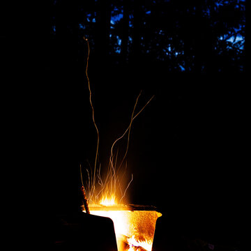 Sparks creep out of fire pit