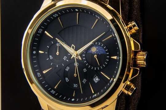 Elegant men&rsquo;s wrist watch with black face, golden details and polished gold bracelet, stylish gift