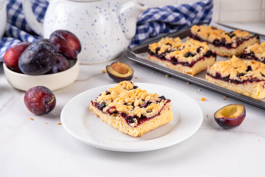 Traditional German Zwetschgenkuchen, plum open pie with crumbled streusel dough topping. Sweet autumn seasonal sweet shortcrust fruit cake